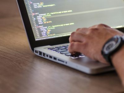 Scalable & Efficient Software Development Developer writing software code with IDE open on screen and task board in background