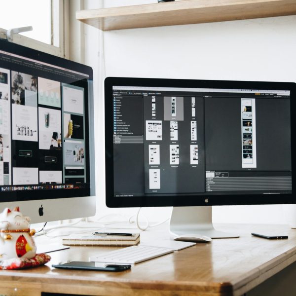 Creative studio desk with iMac running design software
